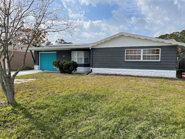 ranch-style house with a front yard and a garage