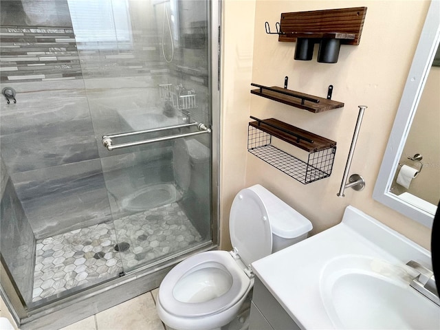 bathroom featuring toilet, vanity, tile patterned floors, and walk in shower