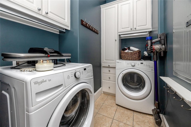 washroom featuring cabinets, light tile patterned floors, and separate washer and dryer