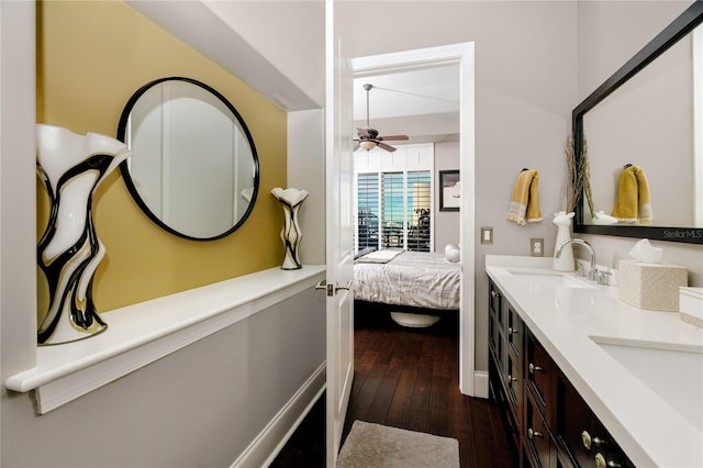 bathroom featuring ceiling fan, wood-type flooring, and vanity