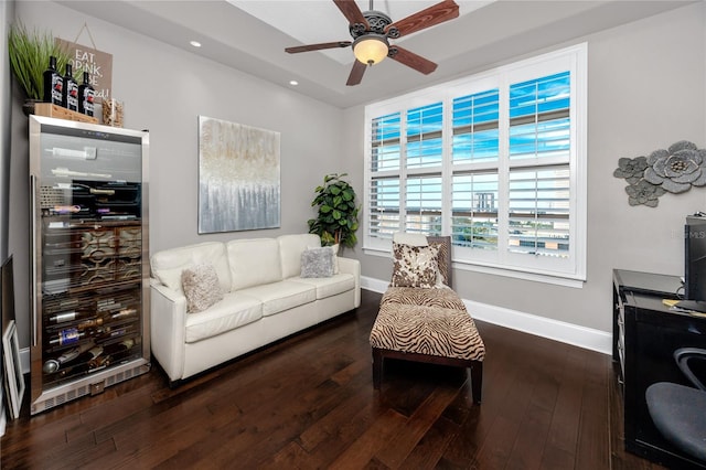 living room featuring ceiling fan, beverage cooler, and dark hardwood / wood-style floors