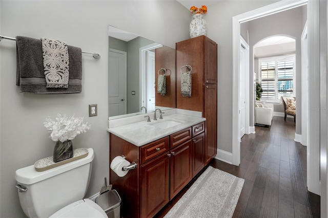 bathroom featuring toilet, hardwood / wood-style floors, and vanity