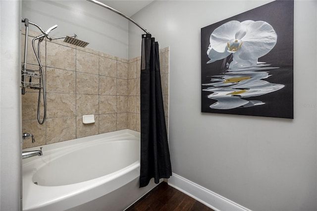 bathroom with hardwood / wood-style floors and shower / tub combo