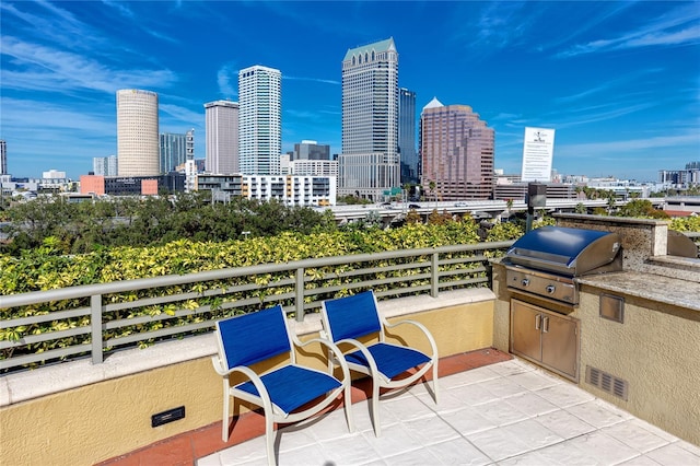 view of patio featuring a balcony and a grill