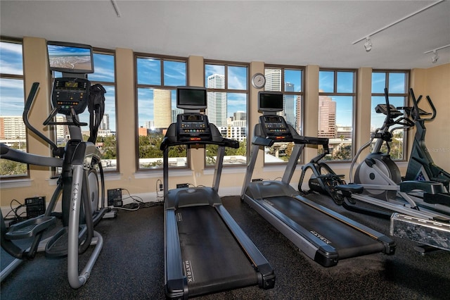 workout area featuring track lighting