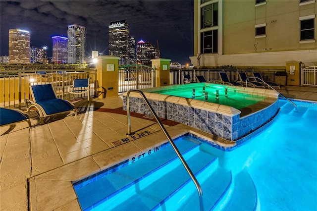 pool at night with a community hot tub