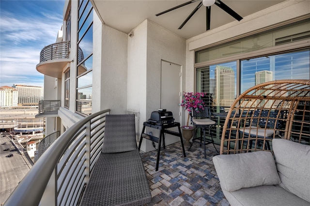 balcony featuring ceiling fan and a grill