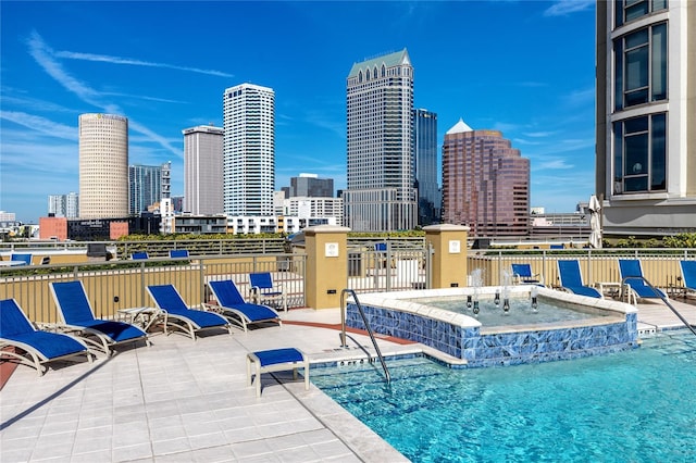 view of swimming pool featuring pool water feature and a patio area