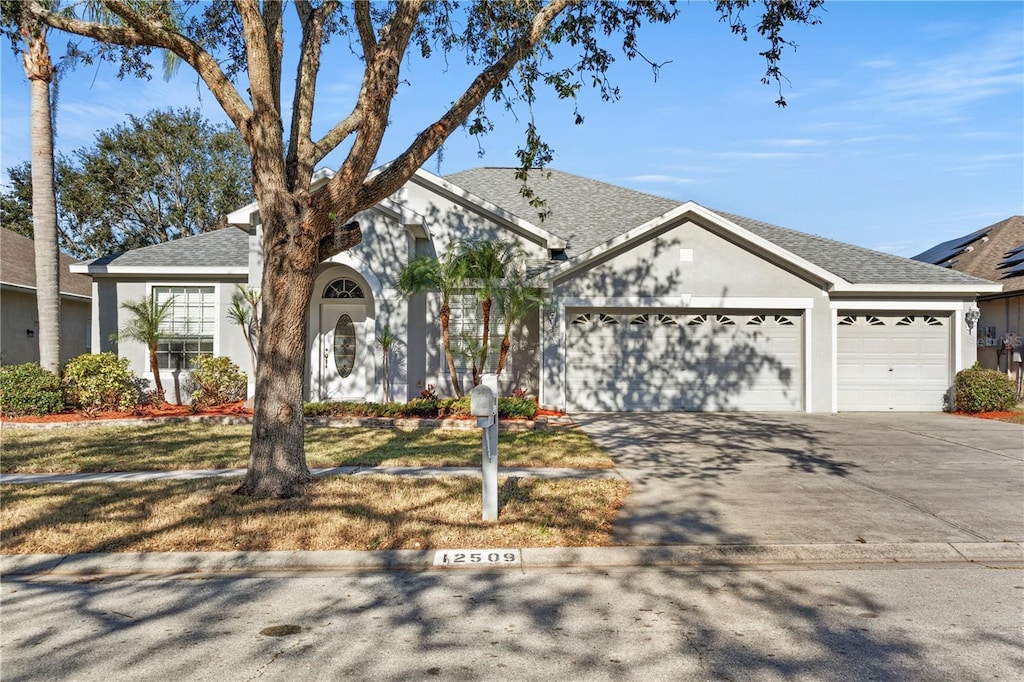 ranch-style home with a front yard and a garage