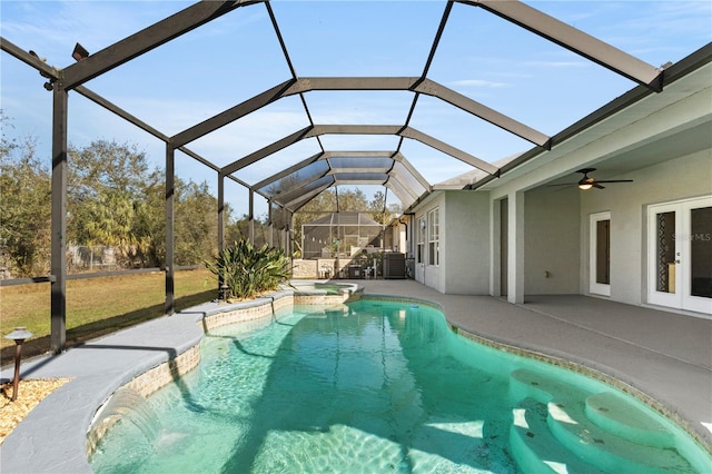 view of swimming pool featuring ceiling fan, a lanai, a patio, and french doors