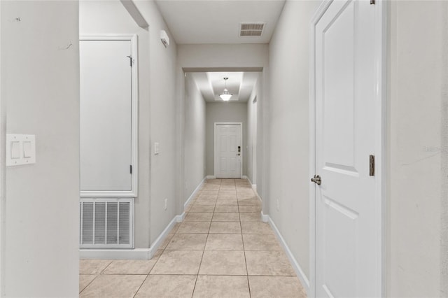 hall featuring light tile patterned floors