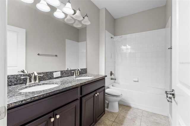 full bathroom with tiled shower / bath, tile patterned floors, toilet, and vanity