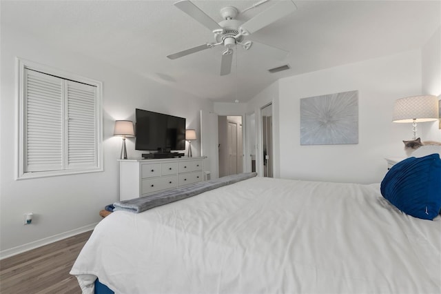 bedroom with hardwood / wood-style flooring, ceiling fan, and a closet