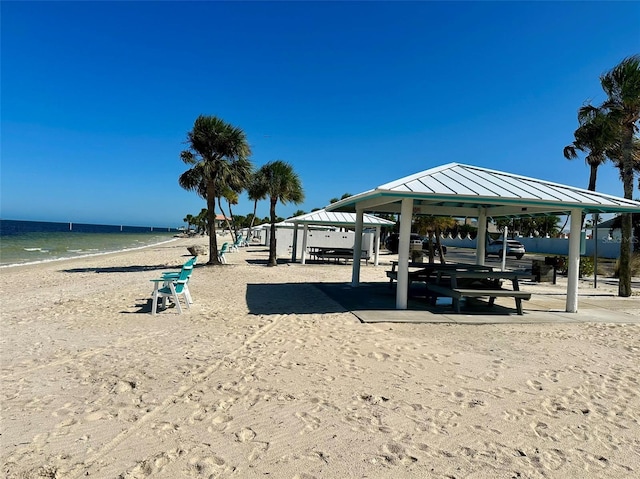 view of home's community with a view of the beach, a gazebo, and a water view