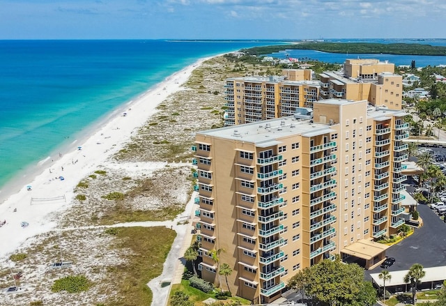 drone / aerial view featuring a beach view and a water view