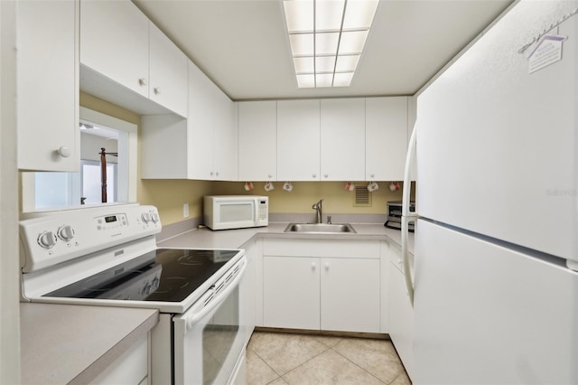 kitchen with white cabinetry, white appliances, and sink