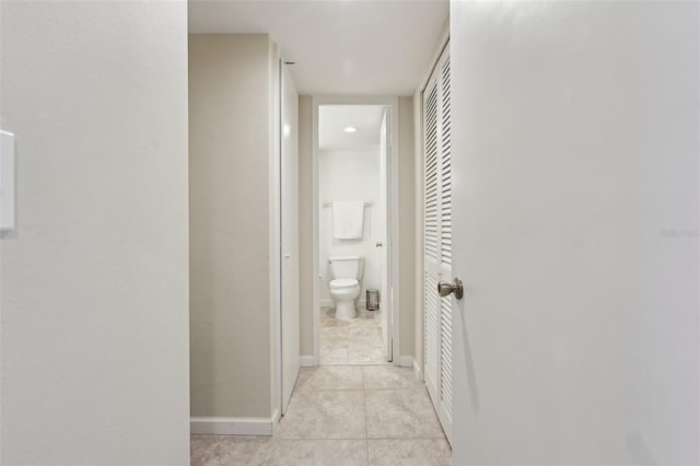 hall with light tile patterned floors