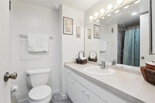 bathroom with curtained shower, vanity, and toilet