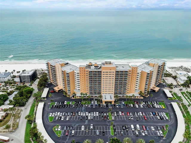 drone / aerial view featuring a water view and a view of the beach