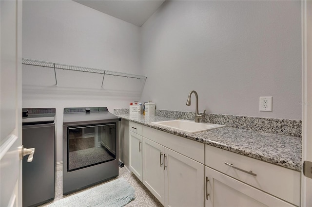 clothes washing area with sink and washing machine and clothes dryer