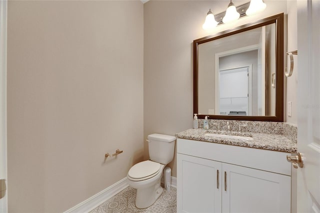 bathroom featuring toilet, vanity, and tile patterned floors