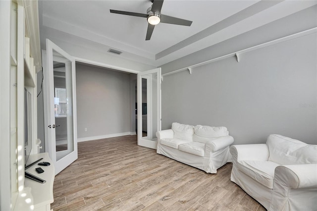 sitting room with french doors, ceiling fan, and light hardwood / wood-style floors