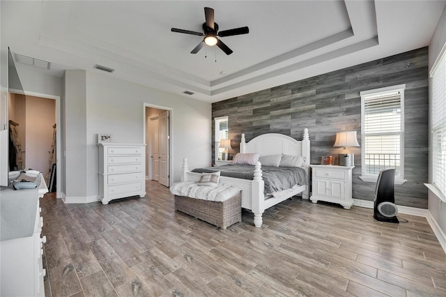 bedroom featuring ceiling fan and a tray ceiling