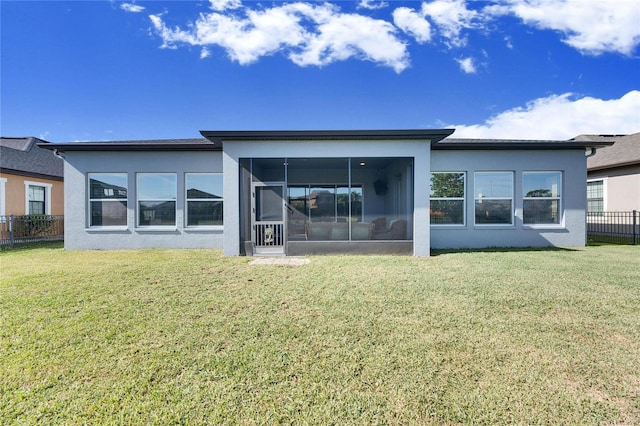 back of house featuring a yard and a sunroom