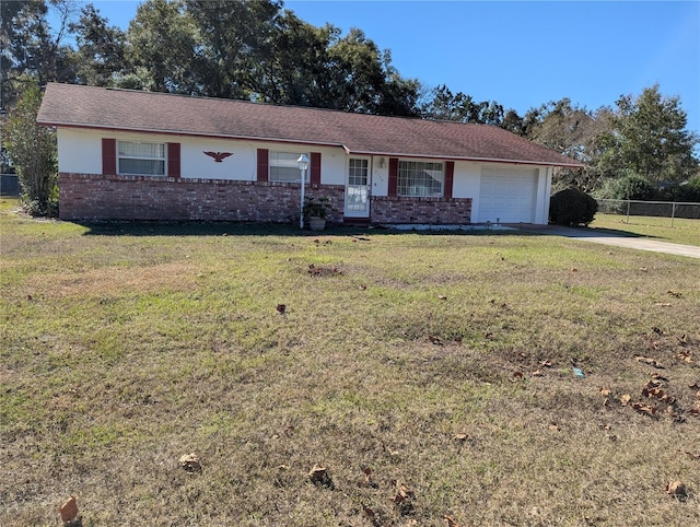 ranch-style house featuring a front lawn and a garage