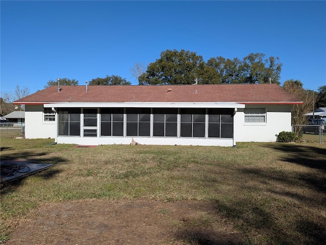 back of house with a sunroom and a yard