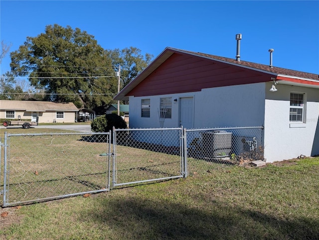 view of side of property with a lawn and central AC unit