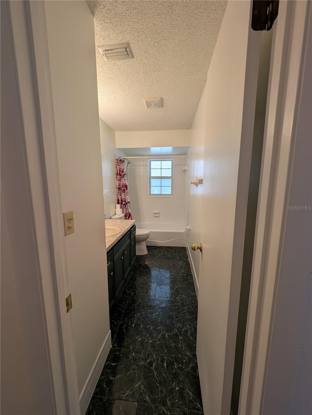 full bathroom featuring vanity, shower / bath combination with curtain, a textured ceiling, and toilet