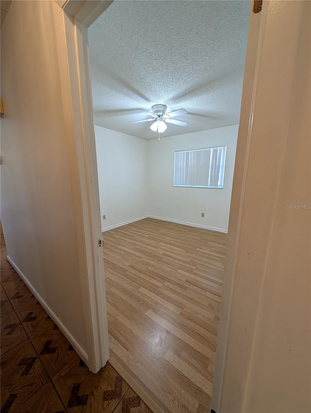 unfurnished room featuring hardwood / wood-style floors and ceiling fan