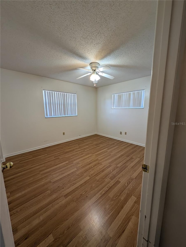 empty room featuring hardwood / wood-style floors and a textured ceiling