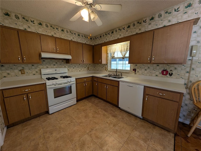 kitchen featuring a textured ceiling, ceiling fan, sink, and white appliances