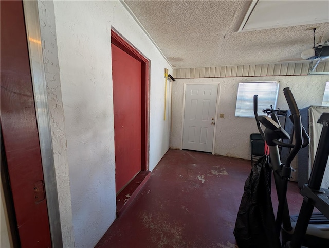 exercise room with a textured ceiling