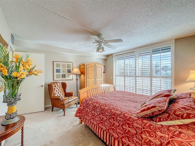 bedroom with carpet, ceiling fan, and a textured ceiling