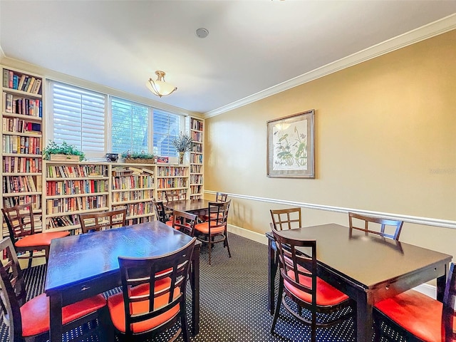 dining space featuring carpet and crown molding