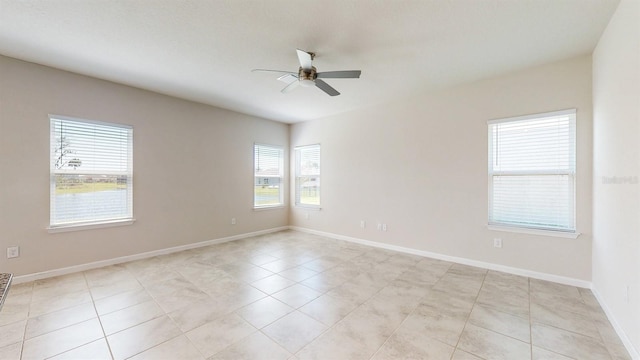 unfurnished room with ceiling fan, a healthy amount of sunlight, and light tile patterned flooring