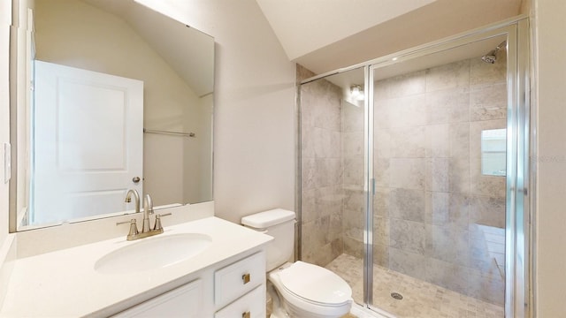 bathroom with vanity, toilet, a shower with door, and lofted ceiling