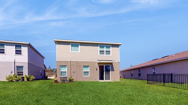 rear view of property featuring a yard