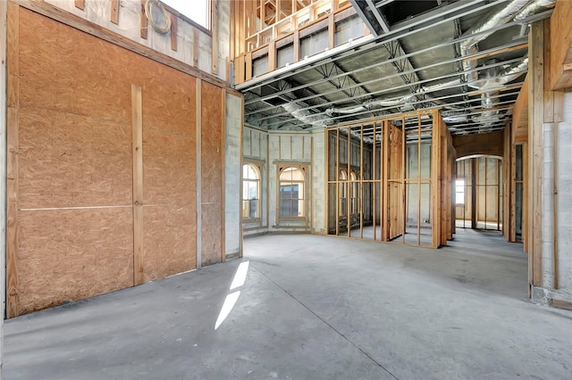 misc room with a healthy amount of sunlight and concrete flooring