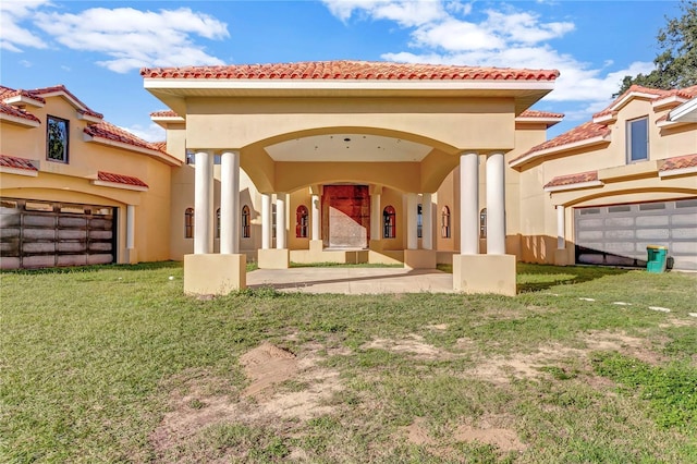 rear view of property with a yard and a garage