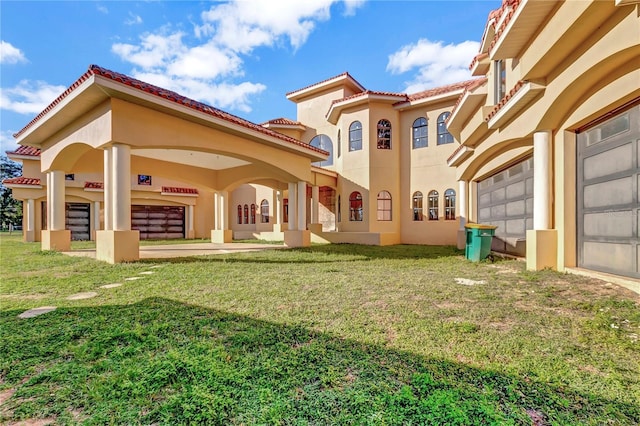 rear view of house with a lawn and a garage