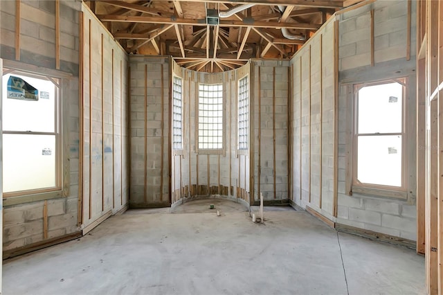 misc room with a wealth of natural light and concrete floors