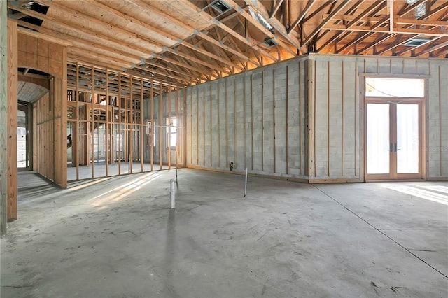 misc room with french doors and concrete floors