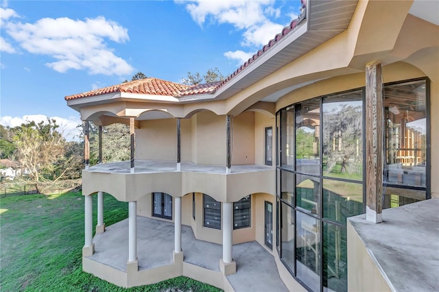 exterior space with a patio area and a front lawn