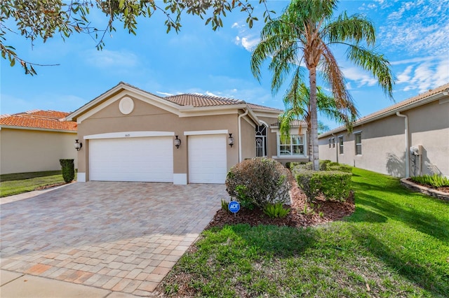 view of front of house with a garage and a front lawn