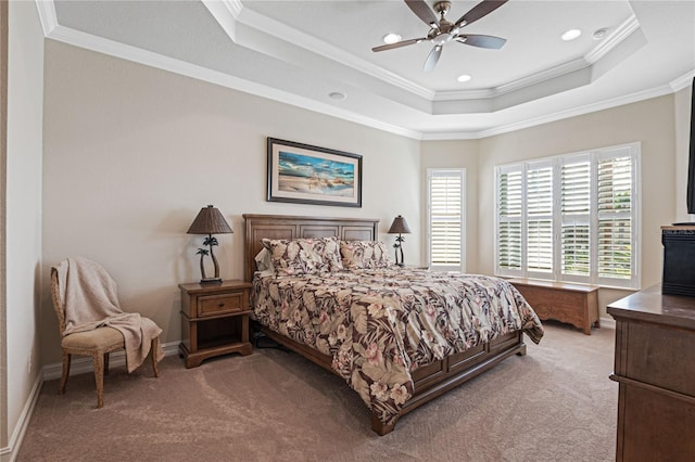 carpeted bedroom with ceiling fan, a raised ceiling, and crown molding