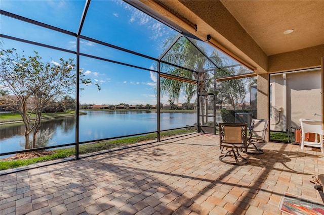 unfurnished sunroom featuring a water view